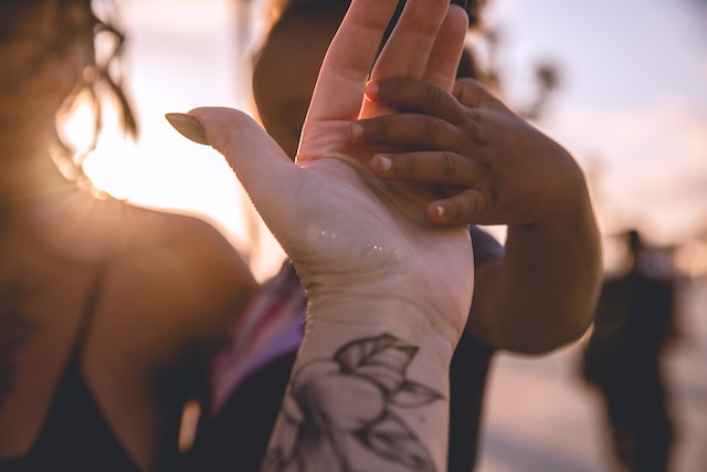 a woman holding her hand to her face