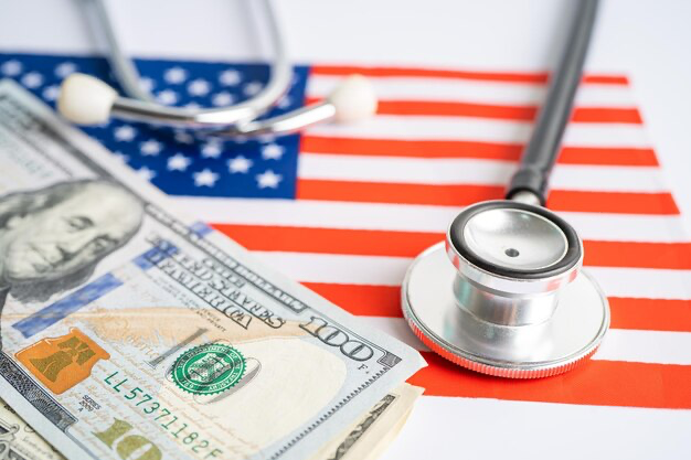 Stethoscope with us dollar banknotes on usa flag background