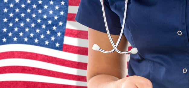 Doctor with a stethoscope on the background of the american flag