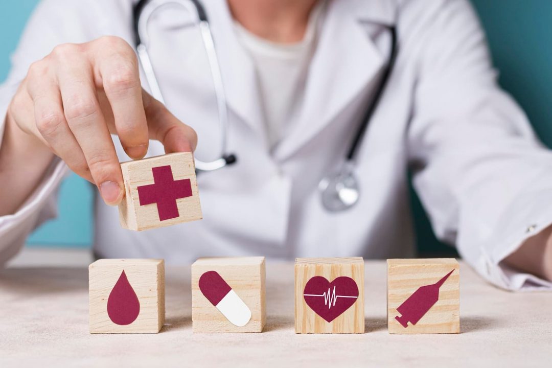 Front view doctor holding cube with medical element